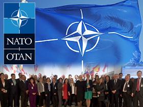 Logo i flaga NATO, poniżej zdjęcie ze spotkania przedstawicieli NOK z IBAN