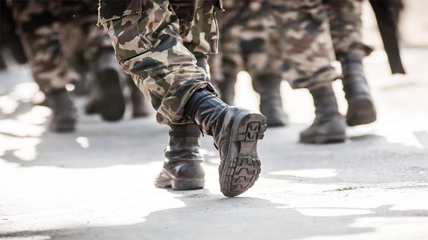 Nogi grupy osób ubranych w mundury i obuwie wojskowe